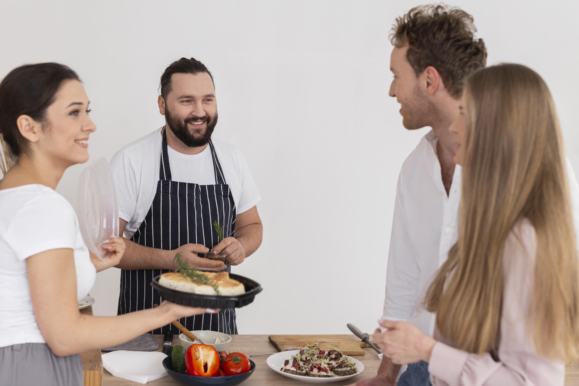 Instructor and student collaborating over a plated dish